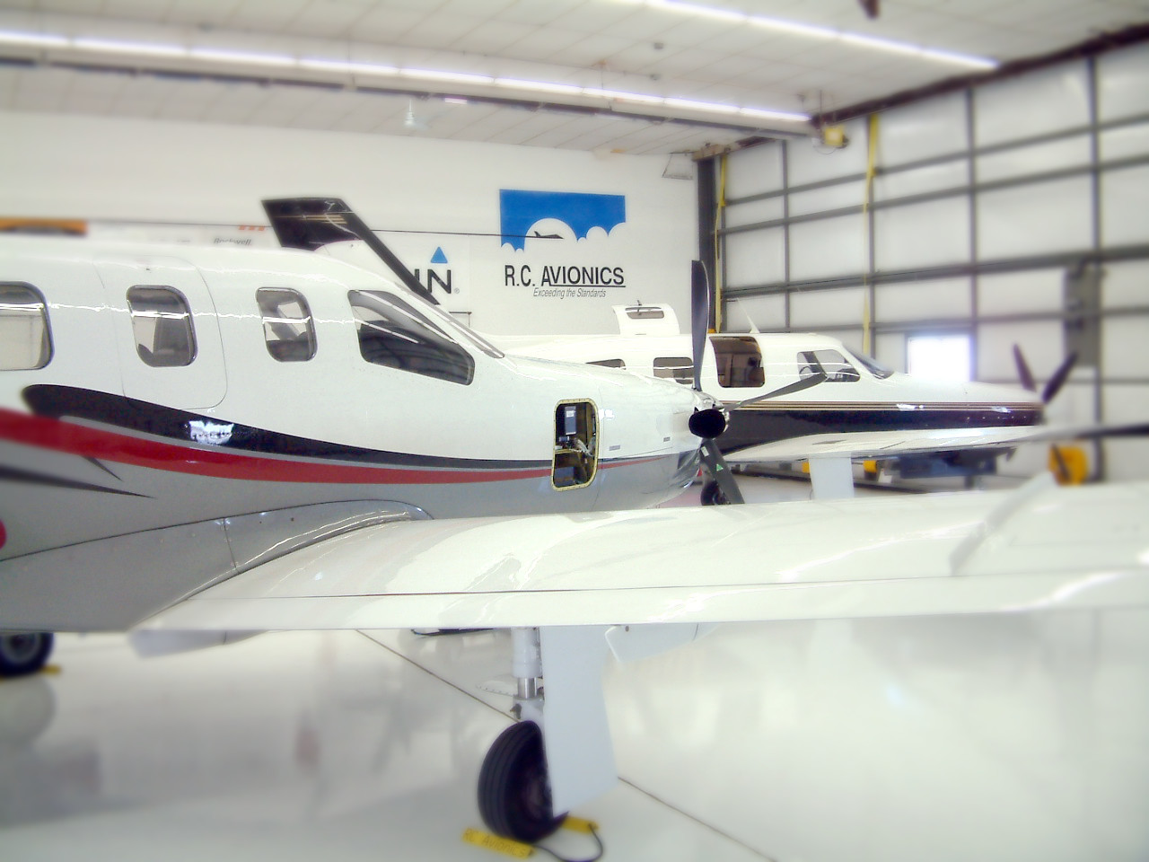 Aircraft inside the R.C. Avionics hangar at Anoka County–Blaine Airport